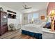 Bright bedroom boasts a ceiling fan, hardwood floors, and a large window at 7118 Overjoyed Xing, Charlotte, NC 28215