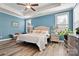 Comfortable bedroom features a tray ceiling, a ceiling fan and lots of natural light at 7118 Overjoyed Xing, Charlotte, NC 28215