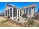 Exterior view of the sunroom featuring a concrete patio and flowers at 7118 Overjoyed Xing, Charlotte, NC 28215
