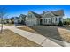 View of several homes in a neighborhood with well-maintained lawns and sidewalks at 7118 Overjoyed Xing, Charlotte, NC 28215