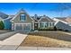 Charming single-story home featuring a well-manicured lawn and an attached two-car garage at 7118 Overjoyed Xing, Charlotte, NC 28215