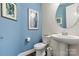 Stylish half bathroom featuring blue walls, a modern sink, and decorative accents at 7118 Overjoyed Xing, Charlotte, NC 28215