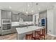 Kitchen features a large island, pendant lights, stainless steel appliances and modern gray cabinetry at 7118 Overjoyed Xing, Charlotte, NC 28215