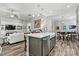Open concept kitchen island with a dishwasher and a view of the living room and dining room at 7118 Overjoyed Xing, Charlotte, NC 28215