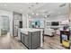 Open concept kitchen features a large island, stainless steel appliances, and a view into the living room at 7118 Overjoyed Xing, Charlotte, NC 28215