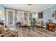 Inviting living room showcasing natural light, wood floors and comfortable furnishings at 7118 Overjoyed Xing, Charlotte, NC 28215