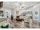 Spacious living room with hardwood floors, elegant decor, and a view of the kitchen at 7118 Overjoyed Xing, Charlotte, NC 28215