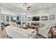 Bright living room with a ceiling fan, comfortable seating, and access to other living spaces at 7118 Overjoyed Xing, Charlotte, NC 28215