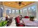 Beautiful sunroom featuring wicker furniture, wood ceilings, and an abundance of windows at 7118 Overjoyed Xing, Charlotte, NC 28215