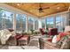 Cozy sunroom featuring wicker furniture, wood ceilings, and an abundance of windows at 7118 Overjoyed Xing, Charlotte, NC 28215