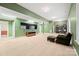 Spacious finished basement features TV, seating, carpeted floors, and shelving at 722 Fairway Point Dr, Fort Mill, SC 29708