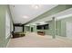 Spacious basement with a home golf simulator, tv, and chair for entertainment at 722 Fairway Point Dr, Fort Mill, SC 29708