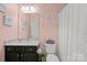 Bathroom features a toilet, mirror, shower curtain, and sink with drawers at 722 Fairway Point Dr, Fort Mill, SC 29708