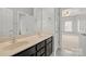 Bathroom with double sinks, black cabinets and an adjoining bedroom view at 722 Fairway Point Dr, Fort Mill, SC 29708