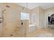 Luxurious bathroom with a glass enclosed shower, soaking tub, and designer tile at 722 Fairway Point Dr, Fort Mill, SC 29708