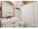 Stylish bathroom with wood accents, modern fixtures, and black-and-white patterned floor tiles near the toilet at 722 Fairway Point Dr, Fort Mill, SC 29708