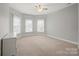 Bright, open bedroom features three windows and a large dresser for ample space at 722 Fairway Point Dr, Fort Mill, SC 29708
