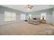 Spacious bedroom features a trey ceiling, neutral carpet, and lots of natural light from the many windows at 722 Fairway Point Dr, Fort Mill, SC 29708