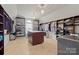 Spacious closet with custom shelving, a center island, and designer chandeliers at 722 Fairway Point Dr, Fort Mill, SC 29708