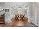 Elegant dining room featuring a coffered ceiling, wainscoting, and a modern chandelier over a wooden table at 722 Fairway Point Dr, Fort Mill, SC 29708
