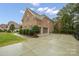 Spacious driveway leading to a brick home, complemented by lush greenery and a well-maintained lawn at 722 Fairway Point Dr, Fort Mill, SC 29708