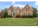 Elegant brick home with a lush green lawn and professionally landscaped front yard, perfect for curb appeal at 722 Fairway Point Dr, Fort Mill, SC 29708