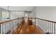 Open hallway featuring gleaming hardwood floors and wrought iron railings at 722 Fairway Point Dr, Fort Mill, SC 29708