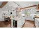 Spacious open kitchen boasts a large center island, stainless appliances, and hardwood floors at 722 Fairway Point Dr, Fort Mill, SC 29708