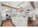 Elegant kitchen with large island, stainless appliances, hardwood floors, and custom lighting at 722 Fairway Point Dr, Fort Mill, SC 29708
