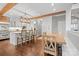 Open concept kitchen with hardwood floors, wooden beams, a large island, and modern lighting at 722 Fairway Point Dr, Fort Mill, SC 29708