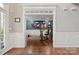 Inviting office space with wainscoting, hardwood floors, and a view to the home's exterior and staircase at 722 Fairway Point Dr, Fort Mill, SC 29708