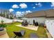 This home's patio offers seating, as well as a grill, lounge chairs, string lights, and a well-maintained yard at 730 Shuttles Way, Fort Mill, SC 29715