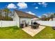 This home's backyard features a stone patio with seating, as well as a grill and fenced in yard at 730 Shuttles Way, Fort Mill, SC 29715
