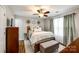 Cozy bedroom featuring neutral tones, wood-look floors, with a comfortable bed and lots of pillows at 730 Shuttles Way, Fort Mill, SC 29715