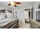 Neutral-toned bedroom featuring carpet floors, fan, and an open doorway leading to the bathroom at 730 Shuttles Way, Fort Mill, SC 29715