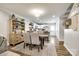 Open dining area featuring a rustic wooden table, hardwood floors, and stylish decor at 730 Shuttles Way, Fort Mill, SC 29715