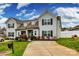 Charming home features a well-manicured lawn, tasteful landscaping, and a private driveway at 730 Shuttles Way, Fort Mill, SC 29715