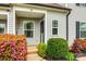 Inviting front porch entrance adorned with colorful foliage, leading to a cozy, well-maintained home at 730 Shuttles Way, Fort Mill, SC 29715