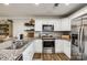 A bright kitchen with granite countertops, stainless steel appliances, and wood-look flooring at 730 Shuttles Way, Fort Mill, SC 29715