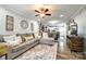 Spacious living room featuring hardwood floors, ceiling fan, and open floor plan leading to kitchen at 730 Shuttles Way, Fort Mill, SC 29715