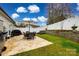 This home's backyard patio offers seating, as well as a grill, lounge chairs, string lights, and a garden at 730 Shuttles Way, Fort Mill, SC 29715