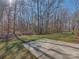 Large backyard with a concrete patio and a wooded perimeter offering privacy for outdoor enjoyment at 8527 Conner Ridge Ln, Charlotte, NC 28269