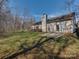 View of the large grassy backyard and the rear of the house featuring a concrete patio at 8527 Conner Ridge Ln, Charlotte, NC 28269
