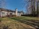 Large grassy backyard with a concrete patio and the rear of the house at 8527 Conner Ridge Ln, Charlotte, NC 28269