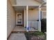 Inviting front porch with white pillars, showing the entrance to the home with a glass paneled front door at 8527 Conner Ridge Ln, Charlotte, NC 28269