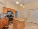 Bright kitchen featuring granite countertops, a center island, and stainless steel appliances at 8527 Conner Ridge Ln, Charlotte, NC 28269