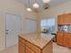 A kitchen with an island, granite countertops, cabinets, and access to a door at 8527 Conner Ridge Ln, Charlotte, NC 28269