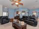Spacious living room with a glass coffee table, comfortable seating, and neutral carpet, bathed in soft, blue light at 8527 Conner Ridge Ln, Charlotte, NC 28269