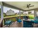 A beautiful covered back deck with outdoor seating and a cozy fire pit area at 8941 Vickery Ln, Harrisburg, NC 28075