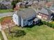 Aerial view of a well-maintained backyard, a covered porch, and a large grassy area at 8941 Vickery Ln, Harrisburg, NC 28075
